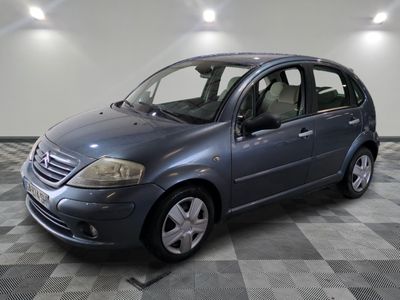 a picture of a blue car parked in a garage