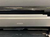 the printer is sitting on top of the table in the room