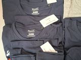 a lot of t - shirts that are on a table