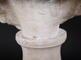 a close up of a statue of a bird on top of a pedestal
