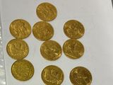 a lot of gold coins sitting on a table