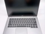 an open laptop computer sitting on top of a white table