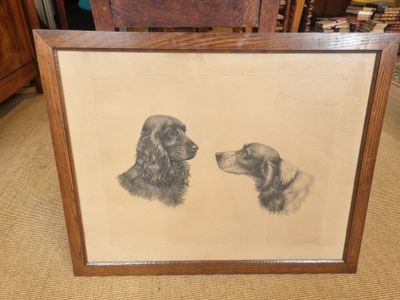 an old picture of two dogs in a frame on the floor
