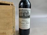 a bottle of wine sitting next to a wooden box