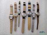 four watches are lined up in a row on a white surface