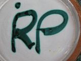 a close up of a ceramic plate with the word r p on it