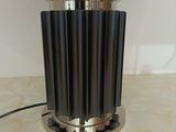 a lamp that is sitting on a table with coins in it