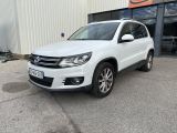 une Volkswagen Tiguan blanche garée devant un immeuble