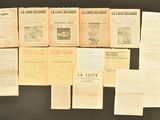 several pages of old french newspapers sitting on a table