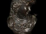 bronze bust of a woman with a bird on her shoulder