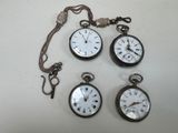 four different types of pocket watches are displayed on a white surface