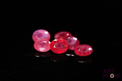 some very pretty pink gems on a black surface