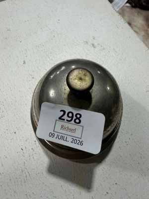 a small metal object on a table with a price tag on it