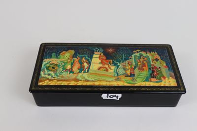 a black box with a painting on it sitting on a table