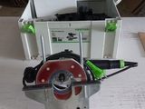someone is using a circular saw to cut a piece of wood