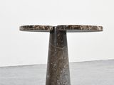 a close up of a table with a marble top on a concrete floor