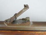 an old gun with a wooden handle on a white background