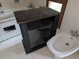 a bathroom with a sink, toilet, and mirror in it