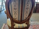 a chair that is sitting on a rug in a room