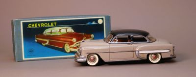 toy car in front of a box with a picture of a car