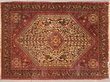 an antique persian rug with a medallion design on a red ground
