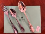 three spoons and a fork sitting on a table