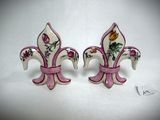 pair of pink and white fleurons with flowers on them