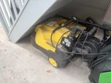 a yellow machine that is sitting under the stairs