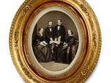an old picture of a group of people in formal attire