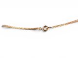 a close up of a gold bracelet on a white background