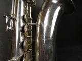 a silver saxophone that is sitting on a table