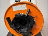 a large orange blower sitting on a wooden floor