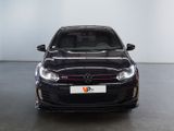 the front of a black volkswagen golf gtr parked in a showroom