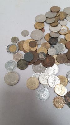 a pile of coins sitting on a white table