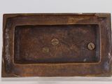a small bronze plate with a picture of a cat on it