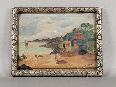 tableau représentant une scène de plage, dans un cadre argenté, accroché à un mur blanc