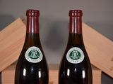 two bottles of wine sitting next to each other on a table