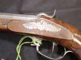 an old gun with a bird emblem on it