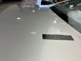 a sticker on the hood of a car in a showroom