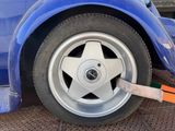a blue car that has a star on the tire