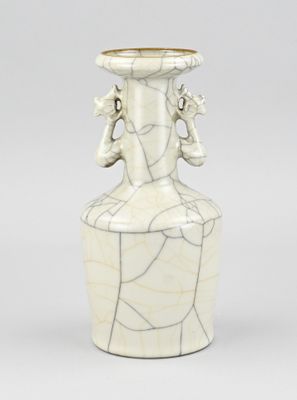 a white vase with a design on the top of it