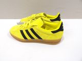 yellow adidas sneakers with black stripes and gum soles