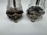 two salt and pepper shakers sitting on a table