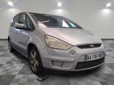 a silver car that is parked on a checkered floor