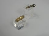 pair of gold and silver rings on clear acrylic stand