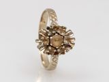 a close up of a gold ring on a white surface