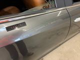 a silver car with a sticker on the side of it