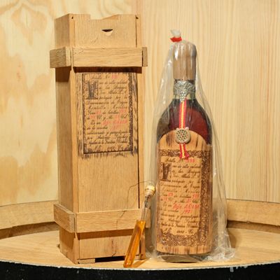 a bottle of wine sitting on a table next to a box