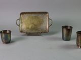 four cups and a tray sitting on a table