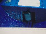 a picture of a picture of a blue boat in the water
